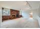 Cozy living room showcasing a brick fireplace, ceiling fan and large windows at 2056 S Newark Way, Aurora, CO 80014