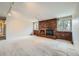 Bright living room with a charming brick fireplace and neutral carpeting at 2056 S Newark Way, Aurora, CO 80014