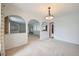 Open living space with neutral carpet, arched openings, and ample natural light at 2056 S Newark Way, Aurora, CO 80014