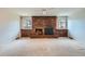 Inviting living room features a brick fireplace, large windows, and neutral carpeting at 2056 S Newark Way, Aurora, CO 80014