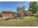 Spacious backyard with a shed and plenty of green space for recreation or relaxation at 7060 Avrum Dr, Denver, CO 80221