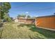 Spacious backyard with shed, mature trees, and plenty of room for outdoor activities at 7060 Avrum Dr, Denver, CO 80221