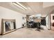Finished basement with carpeted floors, stone accents, and recreational equipment at 7060 Avrum Dr, Denver, CO 80221