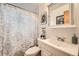Bathroom with a vanity, toilet, shower with patterned curtain, and decorative wall art at 7060 Avrum Dr, Denver, CO 80221