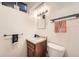 Bathroom with a single sink vanity, lighting fixture and towel rack at 7060 Avrum Dr, Denver, CO 80221
