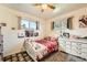 bedroom with white furniture, ample natural light, and colorful decor at 7060 Avrum Dr, Denver, CO 80221