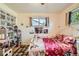bedroom featuring two windows, a patterned rug, and playful decor at 7060 Avrum Dr, Denver, CO 80221