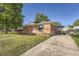 Charming brick home with a well-manicured lawn, inviting curb appeal, and a lovely walkway at 7060 Avrum Dr, Denver, CO 80221