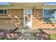 Close up of the front entrance showcasing a brick facade and a well-lit doorway at 7060 Avrum Dr, Denver, CO 80221