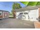 Garage exterior featuring a white door, brick accents, a shed, and potential outdoor seating at 7060 Avrum Dr, Denver, CO 80221