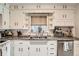 Classic kitchen with white cabinets, granite countertops, stainless steel appliances and tile backsplash at 7060 Avrum Dr, Denver, CO 80221