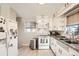 Efficient kitchen with white appliances, granite countertops, ample cabinet space and hardwood floors at 7060 Avrum Dr, Denver, CO 80221