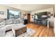 Comfortable living room with a large television, hardwood floors, and natural light at 7060 Avrum Dr, Denver, CO 80221