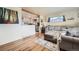 Inviting living room with hardwood floors, a comfortable sofa, and a pass-through to the kitchen at 7060 Avrum Dr, Denver, CO 80221