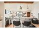 Bright living room featuring a breakfast bar, hardwood floors, and a large window with neighborhood views at 7060 Avrum Dr, Denver, CO 80221