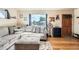 Cozy living room with hardwood floors, a comfortable sofa, and plenty of natural light at 7060 Avrum Dr, Denver, CO 80221