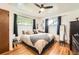Serene main bedroom featuring hardwood floors, natural light and calming decor at 7060 Avrum Dr, Denver, CO 80221