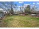 Backyard is large with an mature trees and a wood fence at the rear of the property at 3335 S Verbena Ct, Denver, CO 80231