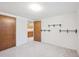 Finished basement room with neutral carpet, wood doors, and additional shelving at 3335 S Verbena Ct, Denver, CO 80231