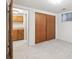 Finished basement room with storage closet, wooden doors, and neutral carpet at 3335 S Verbena Ct, Denver, CO 80231
