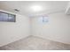 Finished basement room with neutral carpet and natural light from two windows at 3335 S Verbena Ct, Denver, CO 80231