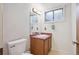 Finished basement half-bathroom features a sink, toilet, and neutral wall color at 3335 S Verbena Ct, Denver, CO 80231