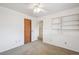 Bedroom with built-in shelving and carpet floors at 3335 S Verbena Ct, Denver, CO 80231