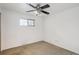Bedroom featuring neutral walls, carpet floors, a ceiling fan and a window at 3335 S Verbena Ct, Denver, CO 80231