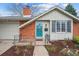 Close up of the charming brick home with a bright blue front door at 3335 S Verbena Ct, Denver, CO 80231