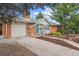 Charming brick home with a two car garage and a well-manicured front yard at 3335 S Verbena Ct, Denver, CO 80231