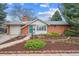 Charming brick home with a well-manicured front yard and a bright blue front door at 3335 S Verbena Ct, Denver, CO 80231