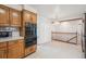 View of kitchen oven and eat in area featuring a hanging light fixture and stair access at 3335 S Verbena Ct, Denver, CO 80231