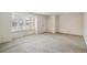 Spacious living room featuring neutral paint, carpet, and a bright window with shutters at 3335 S Verbena Ct, Denver, CO 80231