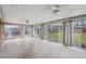 Enclosed sunroom featuring ceiling fans, multiple windows, and access to the backyard at 3335 S Verbena Ct, Denver, CO 80231