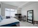 Bright bedroom with large window, desk with computer, and full-length mirror at 1316 Snowberry Ln # 101, Louisville, CO 80027
