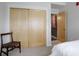 Bedroom with a woven chair and closet with sliding doors for convenient storage at 1316 Snowberry Ln # 101, Louisville, CO 80027