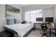 Bright bedroom with a large window and desk with computer at 1316 Snowberry Ln # 101, Louisville, CO 80027