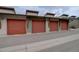 Row of attached garages with modern doors, offering secure parking and storage at 1316 Snowberry Ln # 101, Louisville, CO 80027