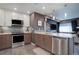 Stylish kitchen featuring sleek appliances, two-tone cabinetry, and a functional island counter at 1316 Snowberry Ln # 101, Louisville, CO 80027