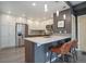 Modern kitchen boasts stainless steel appliances, white cabinets, and a breakfast bar with seating at 1316 Snowberry Ln # 101, Louisville, CO 80027