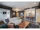 Cozy living room featuring modern furnishings, dark accent walls, and an open layout connecting to the kitchen at 1316 Snowberry Ln # 101, Louisville, CO 80027
