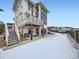 Backyard view with a patio, swing bench and a second story deck with outdoor furniture at 938 Larkspur Ln, Louisville, CO 80027