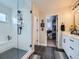 This bathroom features tile flooring, a glass shower, a double-vanity sink, and access to the walk-in closet at 938 Larkspur Ln, Louisville, CO 80027