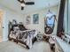 A cozy bedroom featuring a unique hanging chair, ceiling fan, and wall art at 938 Larkspur Ln, Louisville, CO 80027