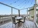 Outdoor deck furnished with a patio table and chairs and string lights for evening ambiance at 938 Larkspur Ln, Louisville, CO 80027