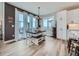 Inviting dining area with a modern chandelier, a dark wood table, and sliding glass doors to the outdoors at 938 Larkspur Ln, Louisville, CO 80027