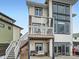 Back exterior view shows a two-story deck, patio and well-manicured landscaping at 938 Larkspur Ln, Louisville, CO 80027