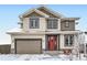 Charming two-story home featuring a red door and a neutral color scheme, complete with an attached two-car garage at 938 Larkspur Ln, Louisville, CO 80027