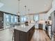 Bright, open kitchen with a large center island, stainless steel appliances, and a seamless flow into the dining area at 938 Larkspur Ln, Louisville, CO 80027