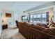 A spacious living room with a large, brown sectional sofa and a view of the fenced-in backyard at 938 Larkspur Ln, Louisville, CO 80027